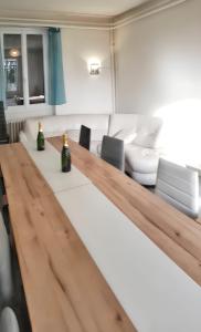 a living room with a table with two bottles on it at Maison de 7 chambres avec jardin clos et wifi a Montsalvy in Montsalvy