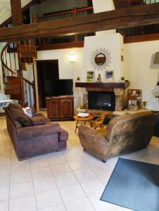 a living room with two couches and a fireplace at Maison traditionnelle Normande avec piscine in Hotot-en-Auge +6 photos