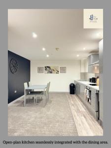 an open plan kitchen seamlessly integrated with the dining area at Flat 501 Chic Apartment Living in Yeadon