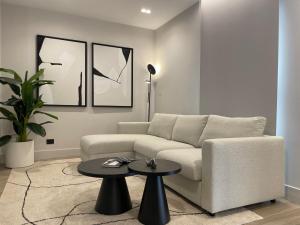 a living room with a couch and a table at Garibaldi Suite 2 Renovated 1BR with Parking, Old Town Olbia in Olbia +51 photos