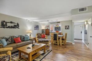 a living room with a couch and a table at Obear Mountain is a Newly Updated Condo in Chalet Village of Gatlinburg! in Gatlinburg