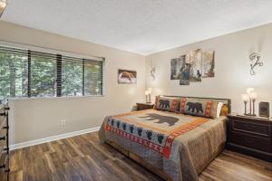 a bedroom with a bed and a window at Obear Mountain is a Newly Updated Condo in Chalet Village of Gatlinburg! in Gatlinburg +25 photos