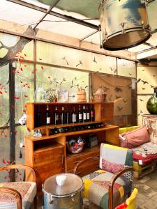 a room with a bunch of wine bottles on a shelf at Divina Hostel in Tirana