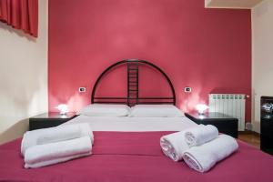 a bedroom with a large bed with a red wall at Villa Melina in Belvedere