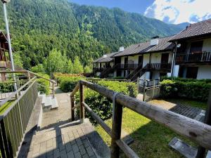 a stairway leading to a building with mountains in the background at Appartamento vista Monte Rosa, giardino in Residence Walser a 10minuti da Macugnaga - MONTEROSAFLAT in Vanzone