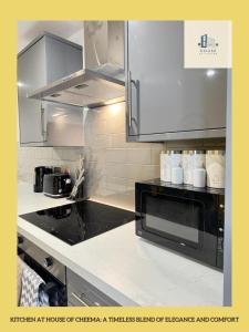 a kitchen with a microwave oven and a counter top at Flat 401 Spacious Two Bedroom in Yeadon