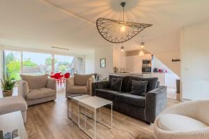 a living room with a couch and a table at Appart 3 chambres avec parking privé et terrasse in Roubaix