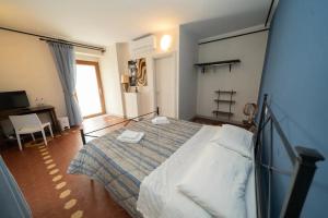a bedroom with a bed and a desk at Affittacamere Borgo degli Artisti boutique rooms in Serricciolo