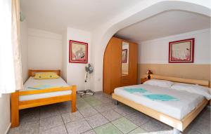 a bedroom with two beds in a room at Lovely Apartment In Rovanjska in Rovanjska