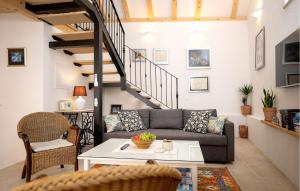 a living room with a couch and a table at 1 Bedroom Gorgeous Home In Vrisnik in Vrisnik