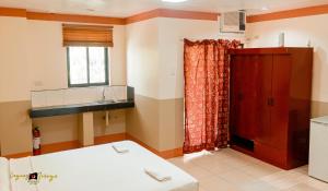 a room with a bed and a window at Imperial Ridge Pension House in Tagbilaran City