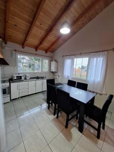a kitchen with a dining room table and chairs at Bungalows Luz del sur in San Carlos de Bariloche