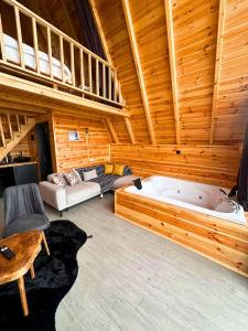 a large living room with a large tub in a cabin at Modul Suit & Bungalov in Rize
