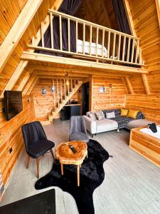 a living room with a staircase in a log cabin at Modul Suit & Bungalov in Rize