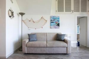 a living room with a couch and a lamp at Appartamento con vista esclusiva sul Golfo d'Ischia in Ischia