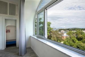 an empty room with a window with a view at Appartamento con vista esclusiva sul Golfo d'Ischia in Ischia +17 photos