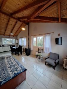 a large living room with a bed and a table at Bungalows Luz del sur in San Carlos de Bariloche