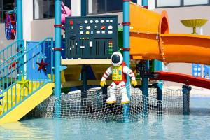Een man in een astronautenpak in een waterpark. bij Jupiter Albufeira Hotel - Family & Fun - All Inclusive in Albufeira