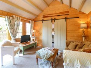 a living room with a bed and a desk at Willow Lodge in Great Yarmouth