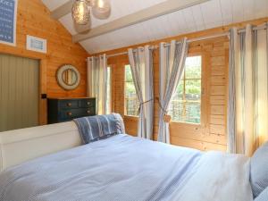 a bedroom with a bed and a window at Willow Lodge in Great Yarmouth