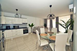 a kitchen and dining room with a table and chairs at Ocean view perfect sunset apartment, 4 rooms 137m2, WiFi & BBQ in San Miguel de Abona