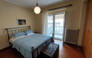 a bedroom with a bed and a large window at Catherine's Beachfront Apartment by Optimum Link in Paralia Katerinis