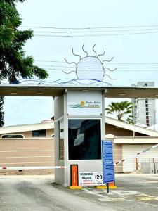 a shell gas station with a sun painted on the top at Suite en zona exclusiva in Manta +4 photos