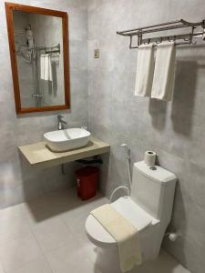 a bathroom with a white toilet and a sink at White Sand Inn in Maamigili +65 photos