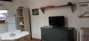A television and/or entertainment centre at Palazzo Saraceno apartments-Antico Rifugio