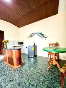 a kitchen with a table and two fish on the wall at Suite en zona exclusiva Manta in Manta +4 photos
