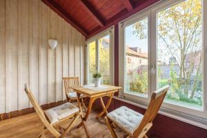 a table and chairs in a room with windows at Wintergartenhaus Braunlage in Braunlage