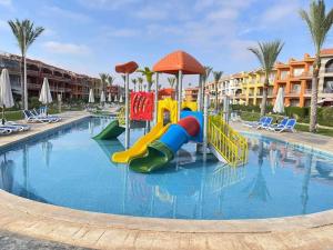 a pool at a resort with a water slide at PORTO MATROUH-GREEN Beach family's only in Marsa Matruh