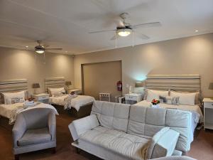 a living room with a couch and two beds at 113 on Robberg in Plettenberg Bay