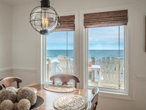 a dining room with a table and a view of the ocean at C-Maid in Surf City