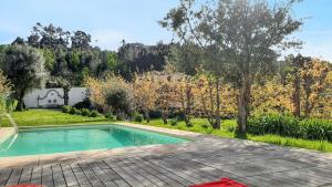 a pool in the backyard of a house at 2 bedrooms house with shared pool enclosed garden and wifi at Covelas Povoa de Lanhoso in Póvoa de Lanhoso