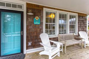 a porch with two chairs and a bench on a house at Wish Upon a Seastar by Seabrook Hospitality in Pacific Beach +35 photos