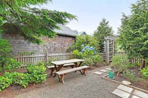 a picnic table in a garden next to a fence at Wish Upon a Seastar by Seabrook Hospitality in Pacific Beach