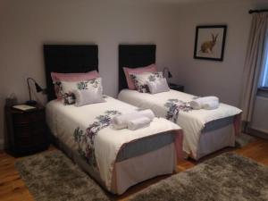 a bedroom with two beds with towels on them at Cherry Tree Guesthouse in Bradford on Avon