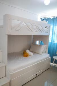 a white bunk bed with a yellow stuffed animal on it at Bonnie house in Crocodile Valley Estates