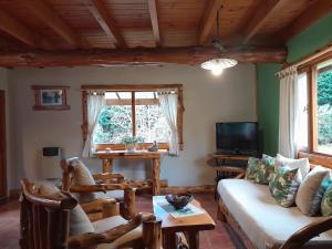 a living room with a couch and a table at Tierras del Sur II in Villa La Angostura