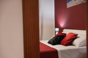 a bedroom with a bed with two pillows on it at A casa di Stefy in Trapani