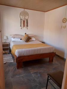 A bed or beds in a room at Casa Ñawi