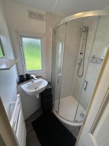 a bathroom with a shower and a sink at Newquay buy resort Holiday in Newquay Bay Resort
