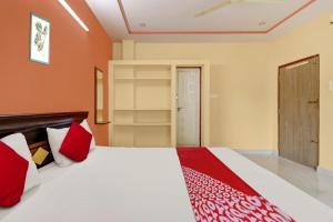 a bedroom with a large bed with red pillows at SEA COASTAL INN-3 in Kākināda +21 photos