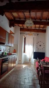 a kitchen with a table and a kitchen with a window at Casina 31 in Città di Castello