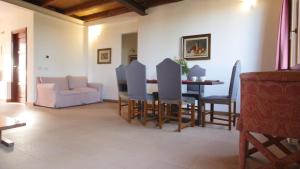 a living room with a table and chairs and a couch at Capalbio - Retreat in Capalbio