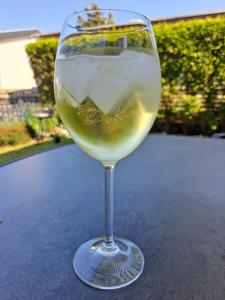a glass of white wine sitting on a table at Chalet Callantsoog in Callantsoog
