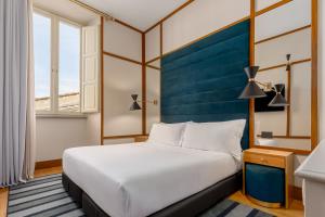 Cama ou camas em um quarto em Room Mate Luca, Florence