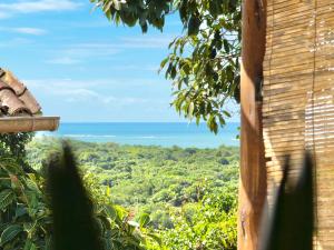 a view of the ocean from a house at Casa Rabanete Trancoso in Trancoso