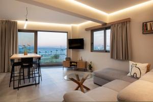 a living room with a couch and a table at 400 Steps Apartment with Sea View near Old Town in Rhodes Town